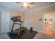 Bright bedroom featuring a ceiling fan and a modern treadmill for a personal workout space at 625 Whispering Pines Ct., Murrells Inlet, SC 29576