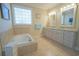 Bright main bathroom with soaking tub and dual sinks at 625 Whispering Pines Ct., Murrells Inlet, SC 29576
