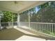 Enclosed back porch with room for seating surrounded by lush trees, perfect for enjoying nature at 625 Whispering Pines Ct., Murrells Inlet, SC 29576