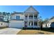 Charming two-story home with a covered porch and manicured lawn on a sunny day at 631 Fair Feather Ct., Myrtle Beach, SC 29588