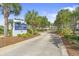 Inviting entrance to Sandpiper Run, featuring lush landscaping and palm trees at 645 Retreat Beach Circle # A-2-C, Pawleys Island, SC 29585