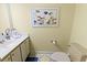 This powder room has a nice sink, toilet, and some decor at 645 Retreat Beach Circle # A-2-C, Pawleys Island, SC 29585