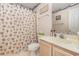 Bathroom with seashell shower curtain and wood vanity at 665 Tupelo Ln. # 17-F, Longs, SC 29568