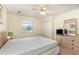 Inviting bedroom with a ceiling fan, ample natural light, and closet space at 665 Tupelo Ln. # 17-F, Longs, SC 29568