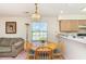 Bright dining area with a round table, four chairs, and natural light from the window at 665 Tupelo Ln. # 17-F, Longs, SC 29568