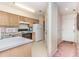 Bright kitchen offering wood cabinetry, white appliances and a neutral-toned floor at 665 Tupelo Ln. # 17-F, Longs, SC 29568
