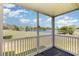 Inviting screened-in porch boasting serene views of the lake and lush golf course at 665 Tupelo Ln. # 17-F, Longs, SC 29568