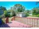 Red deck overlooking large backyard with storage shed and large trees at 703 S 21St Ave. S, North Myrtle Beach, SC 29582