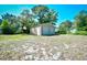 Backyard with storage shed on a sunny day with trees at 703 S 21St Ave. S, North Myrtle Beach, SC 29582