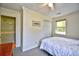 Clean bedroom with a window, ceiling fan, closet, and simple decor creating a relaxing space at 703 S 21St Ave. S, North Myrtle Beach, SC 29582