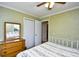 Bright bedroom with a ceiling fan, closet, dresser and mirror offering a comfortable private space at 703 S 21St Ave. S, North Myrtle Beach, SC 29582