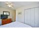 Bright bedroom with a ceiling fan, dresser, closet, and soft patterned bedding at 703 S 21St Ave. S, North Myrtle Beach, SC 29582