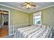 Inviting bedroom with a ceiling fan, window, and doorway access to the home at 703 S 21St Ave. S, North Myrtle Beach, SC 29582