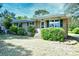 Charming single-story brick home featuring a cozy front porch and lush landscaping at 703 S 21St Ave. S, North Myrtle Beach, SC 29582