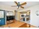 View of the living room, showing access to the kitchen, with a ceiling fan and parquet wood flooring at 703 S 21St Ave. S, North Myrtle Beach, SC 29582