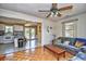 Open living space connecting to the kitchen, with a ceiling fan and access to the outdoor deck at 703 S 21St Ave. S, North Myrtle Beach, SC 29582