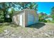 Metal storage shed in backyard with two garage doors and one entry door at 703 S 21St Ave. S, North Myrtle Beach, SC 29582