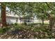 Backyard view featuring a screened-in porch and mature trees, providing shade and privacy at 706 Chippendale Dr., Myrtle Beach, SC 29588