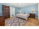 Serene bedroom with light blue walls, a ceiling fan, and wooden floors at 706 Chippendale Dr., Myrtle Beach, SC 29588