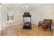 Bright, sunny bonus room featuring a treadmill, a chair, and wood flooring at 706 Chippendale Dr., Myrtle Beach, SC 29588