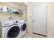 Bright laundry room with a washer, dryer, and shelving for ample storage at 706 Chippendale Dr., Myrtle Beach, SC 29588