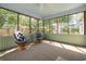 Relaxing screened-in porch with comfortable wicker seating and plenty of natural light filtering through the surrounding trees at 706 Chippendale Dr., Myrtle Beach, SC 29588