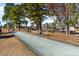 Inviting bocce ball court lined with shade trees provides a leisurely space for outdoor recreation at 7124 Shooting Star Way, Myrtle Beach, SC 29579