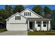 Charming single-Gathering home with white siding, a two-car garage, and a welcoming front porch at 7124 Shooting Star Way, Myrtle Beach, SC 29579