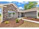Home's exterior with stone accents and fresh landscaping featuring lush plants, and a sidewalk leading to the front door at 718 Highway 348, Loris, SC 29569
