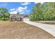 Charming single-story home features a stone facade, attached two-car garage, and long concrete driveway at 718 Highway 348, Loris, SC 29569