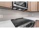 Modern kitchen with stainless steel microwave and oven, complimented by stylish backsplash at 718 Highway 348, Loris, SC 29569