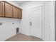 Functional laundry room with overhead cabinets and a convenient door to the outside at 718 Highway 348, Loris, SC 29569