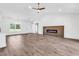 Spacious living room with wood floors, vaulted ceilings, a fireplace, and natural light at 718 Highway 348, Loris, SC 29569