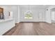 Bright open-concept living space with elegant chandelier, large window, and exterior door for easy access at 718 Highway 348, Loris, SC 29569