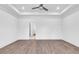 Spacious main bedroom features a tray ceiling, ceiling fan, and ensuite bathroom entrance at 718 Highway 348, Loris, SC 29569