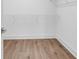 Spacious walk-in closet features wood flooring, white walls, and shelving at 718 Highway 348, Loris, SC 29569