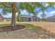 A spacious backyard featuring a covered porch and a lush lawn at 722 Highway 348, Loris, SC 29569