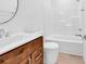Bathroom featuring wood vanity with chrome hardware, a round mirror, and a white shower and tub surround at 722 Highway 348, Loris, SC 29569