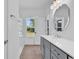 Bright bathroom showcasing double vanity with sleek gray cabinets, framed mirror, and view to outdoors at 722 Highway 348, Loris, SC 29569