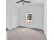 Bright bedroom with neutral carpet, white trim, ceiling fan, and a single window with view of street at 722 Highway 348, Loris, SC 29569