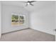 Bright bedroom featuring neutral carpet, a ceiling fan, and a large window overlooking the front yard at 722 Highway 348, Loris, SC 29569