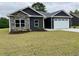 Charming single-story home featuring stone accents and a two-car garage at 722 Highway 348, Loris, SC 29569