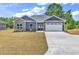 Charming single-story home with stone accents, manicured lawn, and attached two-car garage at 722 Highway 348, Loris, SC 29569