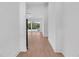 Bright hallway with hardwood floors leading to sliding glass doors and abundant natural light at 722 Highway 348, Loris, SC 29569