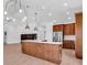 Bright open concept kitchen with wood cabinets, island, stainless steel appliances, and modern lighting at 722 Highway 348, Loris, SC 29569