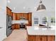 Well-lit kitchen with stainless steel appliances, wooden cabinets, and a white countertop island at 722 Highway 348, Loris, SC 29569