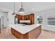 Modern kitchen with wood cabinets, large island with white countertop, and stainless steel appliances at 722 Highway 348, Loris, SC 29569
