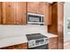 Close up on a stylish kitchen, featuring stainless steel appliances, wood cabinets, and white subway tile at 722 Highway 348, Loris, SC 29569