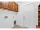 Laundry room with tile flooring, built in wood cabinets, and washer and dryer hookups at 722 Highway 348, Loris, SC 29569