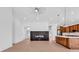 Spacious open floor plan with fireplace, modern kitchen, and light wood floors at 722 Highway 348, Loris, SC 29569
